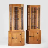 Robert 'Mouseman' Thompson, Pair of oak corner cabinets, each with a glazed cupboard enclosing three glass shelves