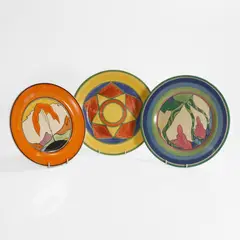 Three pottery plates by Clarice Cliff, c.1930, sold Apr 2025