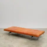 Lit de repos PK 80 by Poul Kjaerholm, A 'PK 80' daybed in chrome-plated steel, lacquered plywood, leather and rubber by Poul Kjaerholm designed in 1957 and ed, sold Nov 2024
