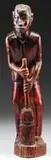 Nancy Elizabeth Prophet, Tending to the Chores, Stained wood sculpture of a black man standing holding on to a natural straw broom