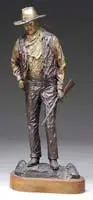 David Manuel, John Wayne – American, Outstanding bronze sculpture of a standing John Wayne in western outfit holding a rifle and wearing a hat