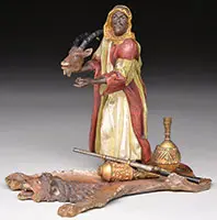 Franz Xavier Bergman Foundry, Arab Holding Sable Antelope Head on Lion Rug, Cold-painted polychromed bronze Foundry mark stamped, also Geschutzt and numbered 474