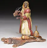Franz Xavier Bergman Foundry, Arab Holding Sable Antelope Head on Lion Rug, Cold-painted polychromed bronze Foundry mark stamped, also Geschutzt and numbered 474
