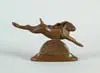 Steve Kestrel, Leaping Rabbit, Brown patina bronze of a leaping jackrabbit. Figure rests atop bronze half circle on an oval base