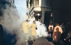 Joel Meyerowitz, Camel coat couple in street steam, New York City, 1975, Dye transfer print