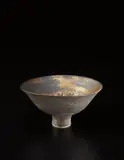 Footed bowl by Lucie Rie, circa 1974, Porcelain, golden manganese and matte black glaze, offered Dec 2014