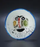 Visage no. 203 (Face no. 203) by Pablo Picasso, 1963, White earthenware round plate painted in gray patina and colors with enamel and partial brushed glaze,, sold Apr 2013