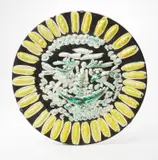 Visage Tourmenté (Tormented Face) by Pablo Picasso, 1956, White earthenware round dish painted in patina, yellow, green and black with partial brushed glaze,, sold Apr 2013