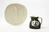 Visage de Faune (Faune’s Head); and Têtes (Heads) by Pablo Picasso, 1955; and 1956, Two white earthenware ceramics, including one round/square plate and one turned pitcher painted in white enamel and blac, sold Apr 2013