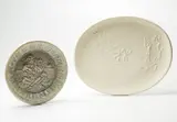 Joueur de Flûte (Flute Player); and Danseurs et Joueur de Diaule (Dancers and Diaulos Player) by Pablo Picasso, 1951; and 1956, Two white earthenware dishes, including one hallow plate covered with white enamel and one oval dish,, sold Apr 2013