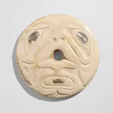 Tlingit, Spindle whorl with carved face, bone, mother-of-pearl