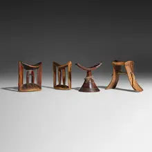 Collection of four headrests by African, carved wood, fabric, sold Dec 2025