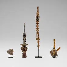 African, Collection of four pipes, brass, bone fragments in binder, carved wood, earthenware