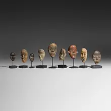 Collection of nine passport masks by Dan, carved wood, Cowrie shells, sold Dec 2025