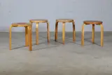 Group of four 'Model 60' stools by Alvar Aalto, 1933, each with a circular birch seat raised on birch bentwood supports, sold Jan 2025