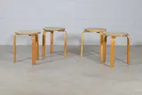 Group of four 'Model 60' stools by Alvar Aalto, 1933, each with a circular birch seat raised on birch bentwood supports, sold Jan 2025