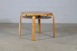 'Model 70' coffee table by Alvar Aalto, 1933, the circular birch top over an undertier shelf and raised on four birch bentwood supports, sold Jan 2025