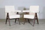 Pair of 'Committee' chairs by Pierre Jeanneret, c.1953, each with studded pale upholstery, sold Jan 2025