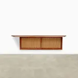 Hanging Wall Cabinet by George Nakashima, American black walnut, the top with free edge, pandanus cloth, the interior with four drawers and three shelves, sold Jun 2024