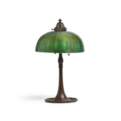 Table Lamp by Tiffany Studios, decorated Favrile glass, patinated bronze, based stamped 'TIFFANY STUDIOS NEW YORK 612', sold Mar 2024