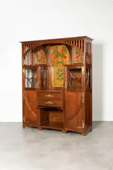 Vaisselier haut by Gustave Serrurier-Bovy, Mahogany, brass hinges and handles, with two drawers and two side doors (six shelves), offered Dec 2023