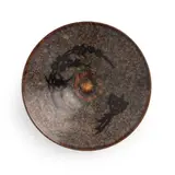 The interior is decorated with a bird and a branch of plum blossoms, the base is with an ink mark. With a Japanese wooden box. by Possibly Southern Song Dynasty A Fine Chinese 'Jizhou' Paper-Cut Resist-Decorated Conical Bowl, sold Aug 2026