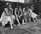 André Kertész, Ballet Dancers sitting on ledge, July