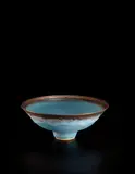 Footed bowl by Lucie Rie, circa 1980, Stoneware, matte blue glaze with golden manganese lip, sold Jun 2013