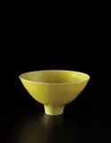 Footed bowl by Lucie Rie, circa 1976, Porcelain, glassy yellow glaze, sold Jun 2013