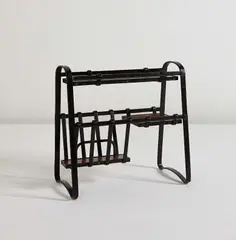 Magazine rack by Jacques Adnet, circa 1950, Leather-covered metal, stained oak, painted wood, sold Dec 2013