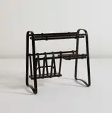 Jacques Adnet, Magazine rack, circa 1950, Leather-covered metal, stained oak, painted wood