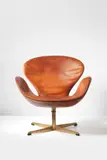 "Swan" swivel chair, designed for the Royal Hotel for SAS, Copenhagen by Arne Jacobsen, 1958, Leather, bronze, sold Dec 2013