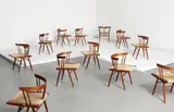 Set of twelve grass-seated chairs by George Nakashima, circa 1960, American black walnut, woven sea grass, sold Dec 2013