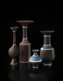Miniature vase by Lucie Rie, circa 1980, Porcelain, golden manganese and matte blue glazes, sgraffito , unglazed bands and inlaid lines, sold Dec 2013