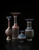 Early "Flask" bottle by Lucie Rie, circa 1955, Porcelain, manganese and matte blue glazes, unglazed bands and sgraffito, sold Dec 2013