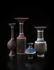 Vase with flaring lip by Lucie Rie, circa 1976, Porcelain, manganese and matte blue glazes, sgraffito lip and shoulder and three inlaid bands, sold Dec 2013