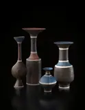 Vase with flaring lip by Lucie Rie, circa 1976, Porcelain, manganese and matte blue glazes, sgraffito lip and shoulder and three inlaid bands, sold Dec 2013