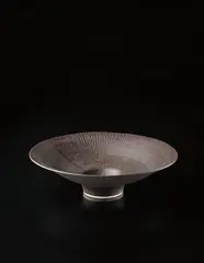 Large open form bowl by Lucie Rie, circa 1980, Porcelain, manganese glaze with radiating sgraffito design, sold Dec 2013