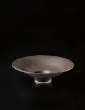 Large open form bowl by Lucie Rie, circa 1980, Porcelain, manganese glaze with radiating sgraffito design, sold Dec 2013