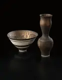 Deep conical bowl by Lucie Rie, circa 1982, Porcelain, golden manganese glaze with bands of inlaid and sgraffito grid designs, sold Dec 2013