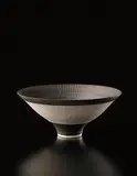 Flaring footed bowl by Lucie Rie, circa 1978, Porcelain, golden manganese glaze, radiating inlaid and sgraffito design, sold Dec 2013