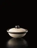 Lidded pot by Lucie Rie, circa 1956, Porcelain, radiating inlaid design, manganese and matte blue glazes on the interior, sold Dec 2013