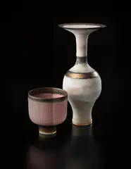Bottle with flaring lip by Lucie Rie, circa 1978, Stoneware, inlaid shoulder and lip, gold bands and matte white glaze, sold Dec 2013
