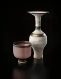 Bottle with flaring lip by Lucie Rie, circa 1978, Stoneware, inlaid shoulder and lip, gold bands and matte white glaze, sold Dec 2013
