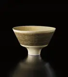 Footed bowl with inlaid band by Lucie Rie, circa 1954, Porcelain, pale yellow glaze over wide band of inlaid grid design, sold Dec 2013