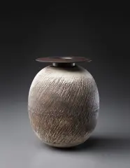 Ovoid volume with disc top by Hans Coper, circa 1969, Stoneware, layered white porcelain slips and engobes over a body with textured and incised linear designs, the interior , sold Dec 2013