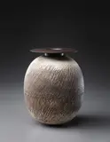 Ovoid volume with disc top by Hans Coper, circa 1969, Stoneware, layered white porcelain slips and engobes over a body with textured and incised linear designs, the interior , sold Dec 2013