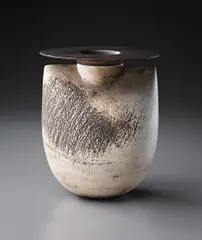 "Sack and disc" form by Hans Coper, circa 1969, Stoneware, layered white porcelain slips and engobes over a body with textured and incised linear designs, the interior , sold Dec 2013
