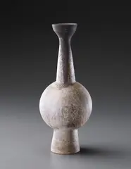 Tall bottle vase with central ovoid volume by Hans Coper, circa 1956, Stoneware, layered white porcelain slips and engobes over a body with textured and incised linear designs, the interior , sold Dec 2013