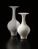 Bottle vase with flared lip by Lucie Rie, circa 1976, Stoneware, matte white glaze with a manganese speckle, sold Dec 2013